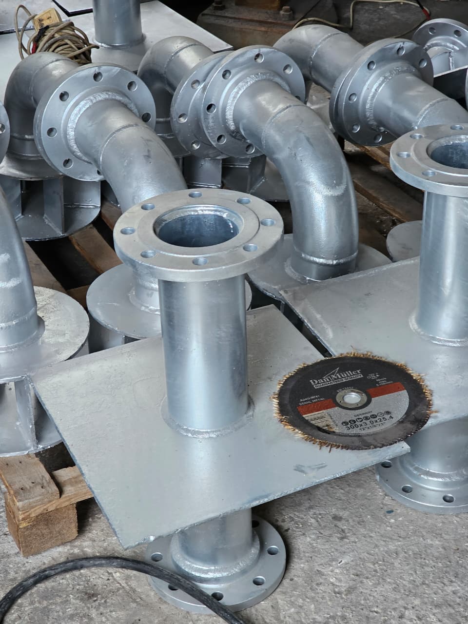 Galvanized pipe spools and fabricated supports arranged for finishing