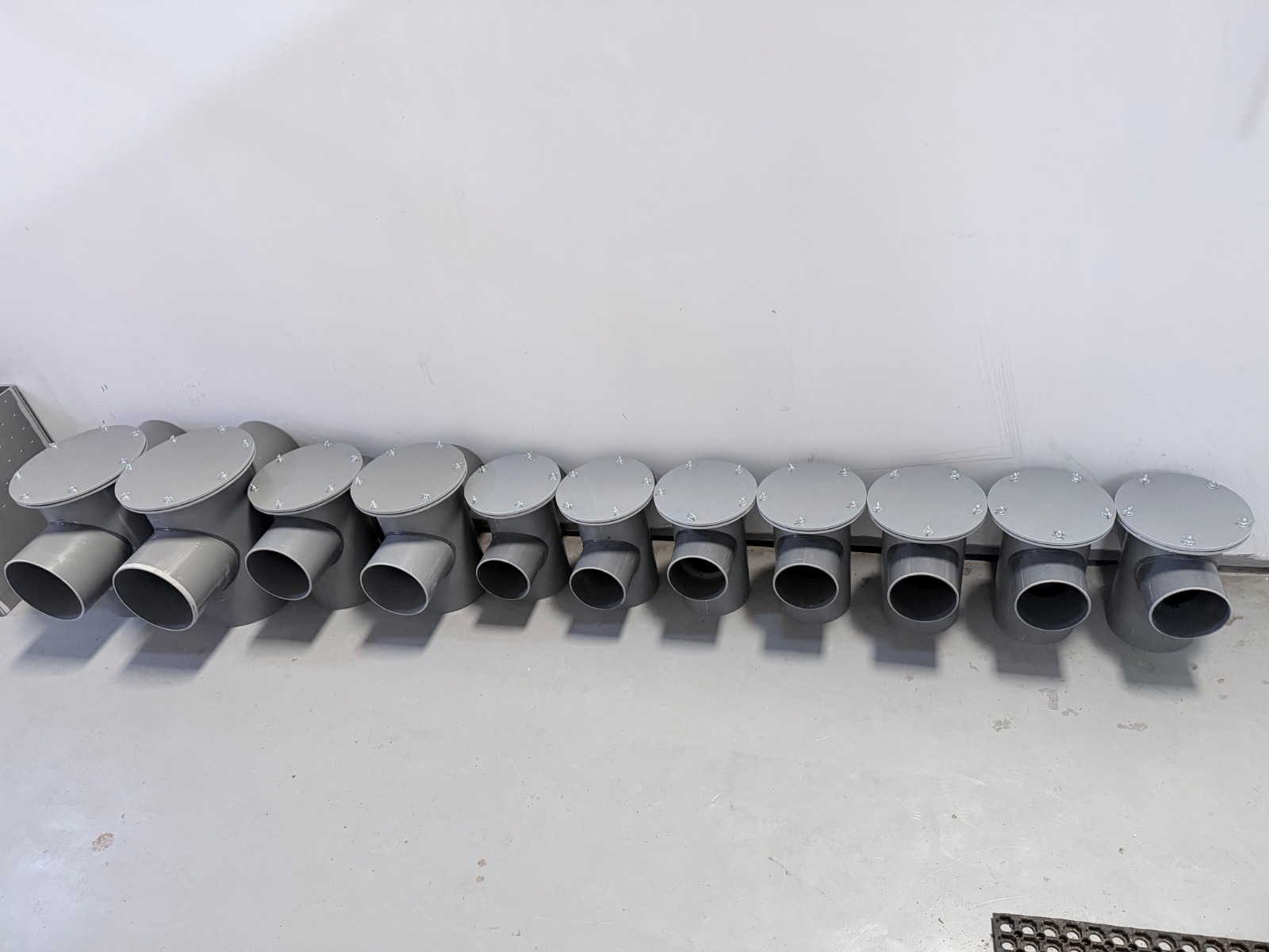 Fabricated grease traps with bolted covers arranged in the workshop