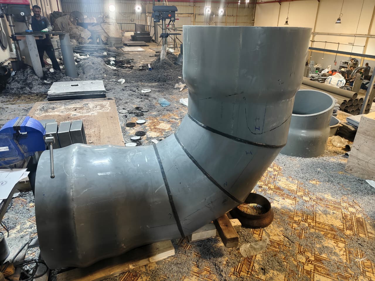 Large segmented PVC elbow under fabrication in the workshop